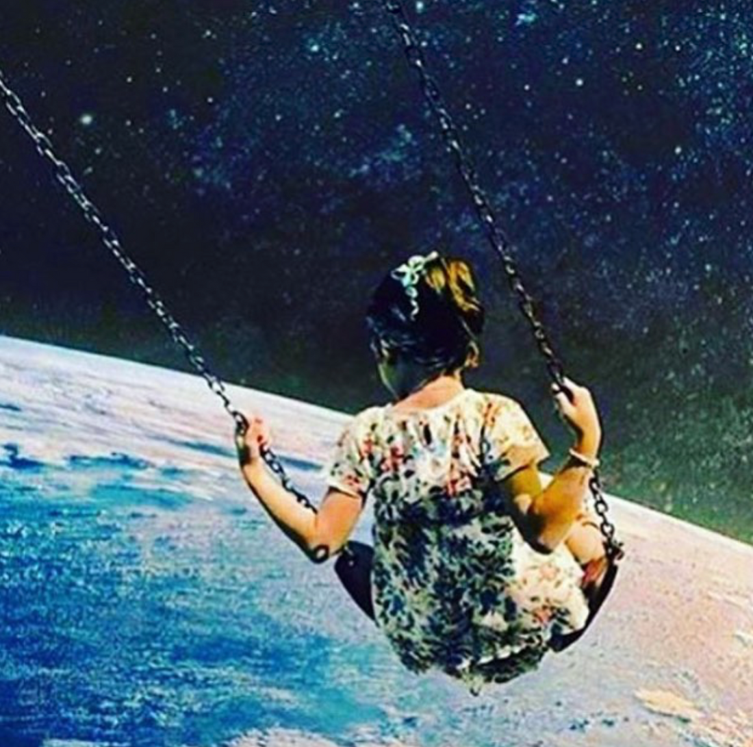Girl on swing in universe