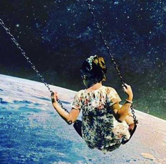 Girl on swing in universe